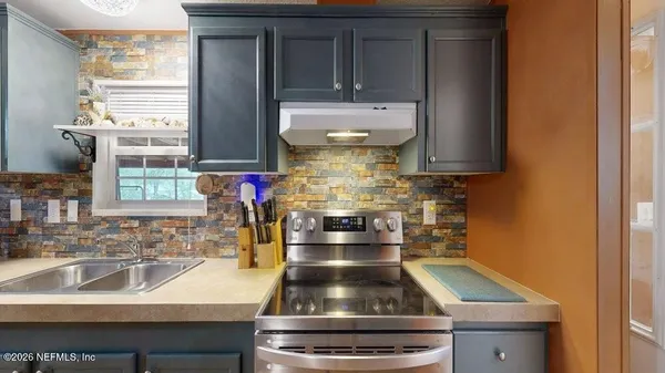 a kitchen with a stove and a sink