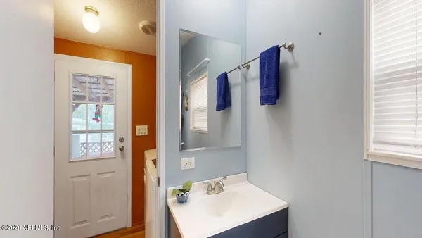 a bathroom with a sink and mirror