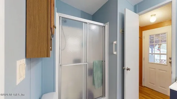 a bathroom with a glass shower door