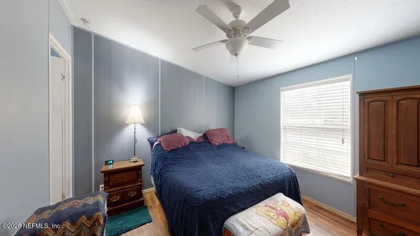 a bedroom with a bed and a chandelier