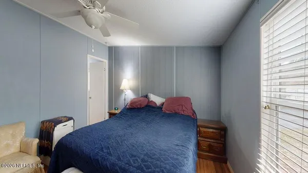 a bed room with a bed and a chandelier