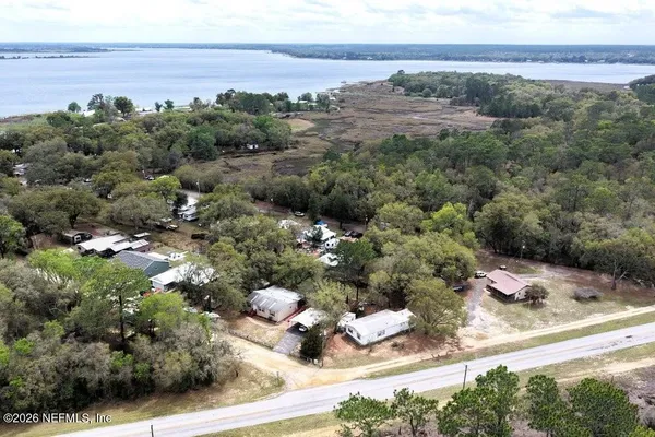 an aerial view of a house with a yard