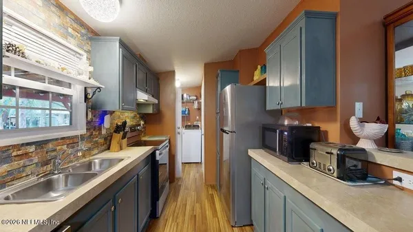 a kitchen with a sink stove and refrigerator