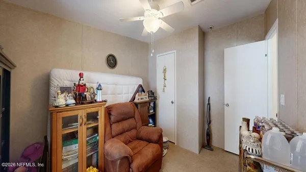 a living room with furniture and a bed