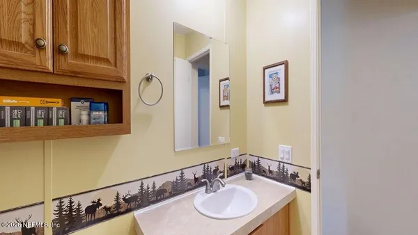 a bathroom with a sink and a mirror