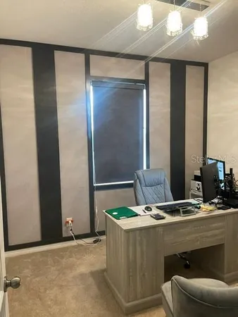 a dining room with furniture and window