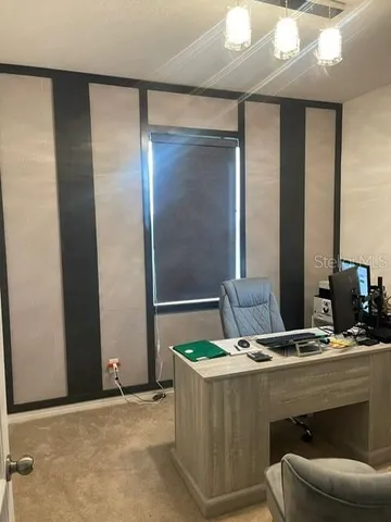 a dining room with furniture and window