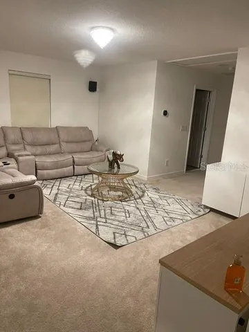a living room with furniture and a rug