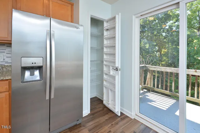 a bathroom with a glass shower door and a window
