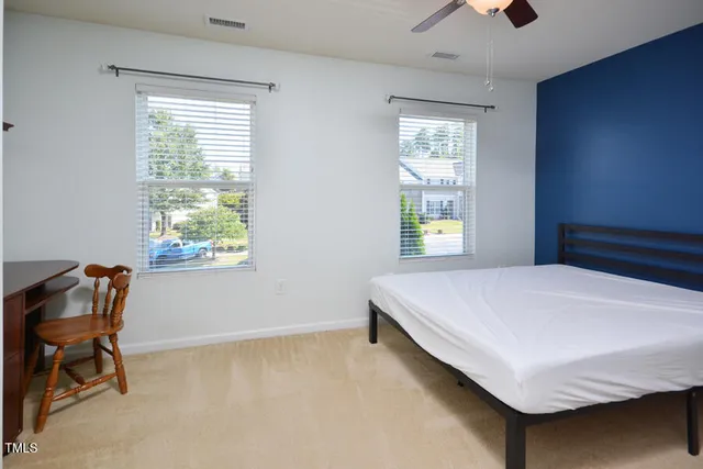 a bed sitting in a bedroom next to a window