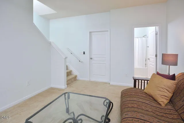 a living room with furniture and stairs