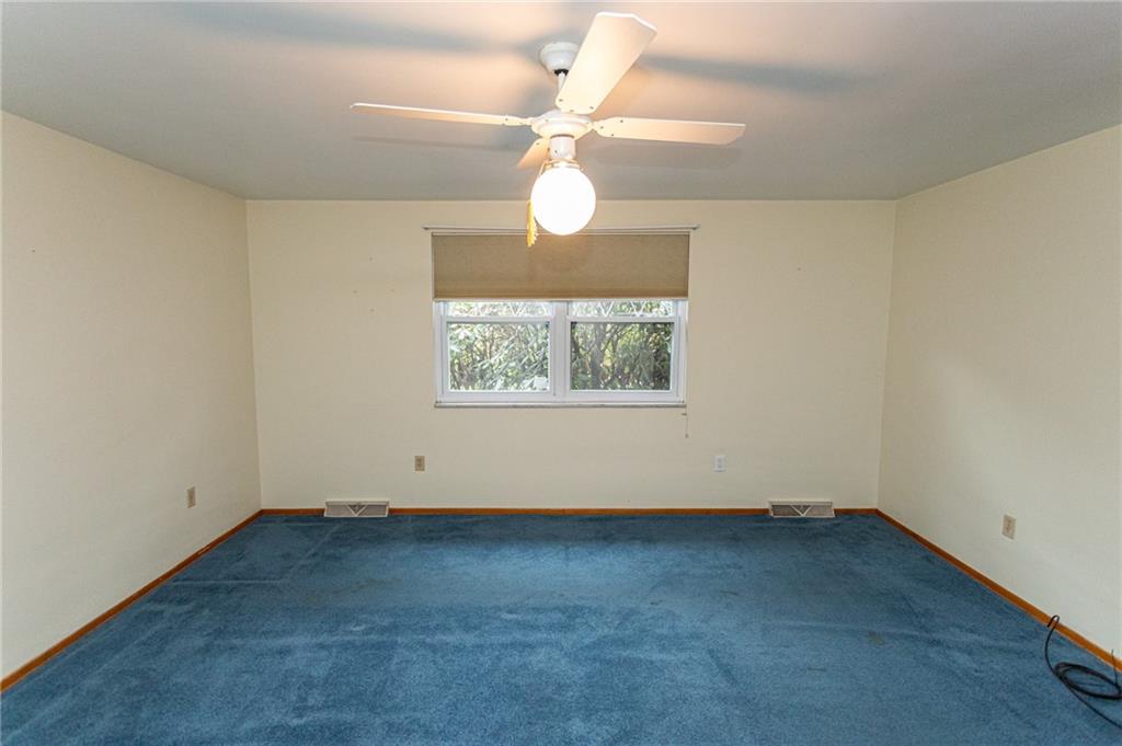 673 Vanderbilt Road Connellsville, PA 15425 - Photo 16 of 28 an empty room with a window and a fan