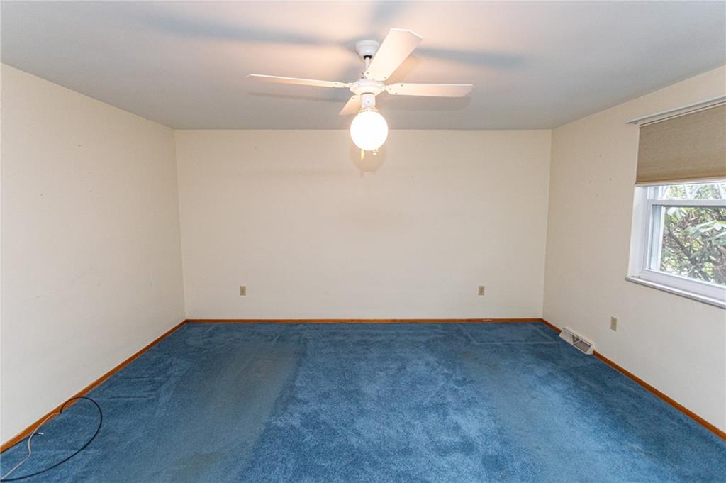 673 Vanderbilt Road Connellsville, PA 15425 - Photo 18 of 28 wooden floor in an empty room with a window