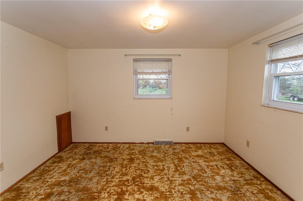 673 Vanderbilt Road Connellsville, PA 15425 - Photo 20 of 28 an empty room with wooden floor and windows