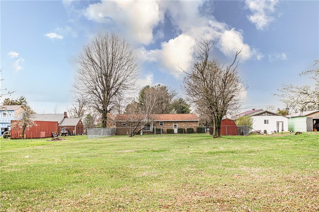 673 Vanderbilt Road Connellsville, PA 15425 - Photo 2 of 28 a view of a house with a big yard and large trees