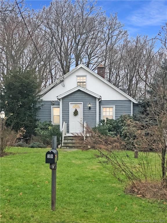 39 Wakemore Street Darien, CT 06820 - Photo 1 of 1 a front view of house with yard and green space