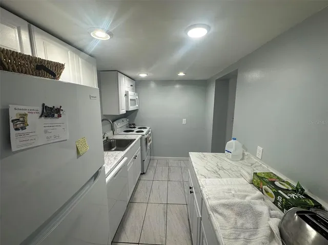 a kitchen with a sink and appliances
