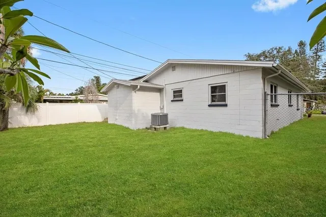 a view of a backyard with plants and a patio