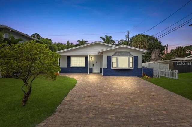 a front view of a house with a garden