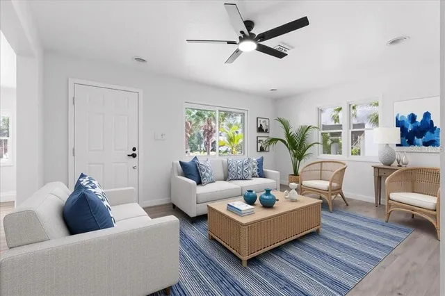 a living room with furniture and a wooden floor