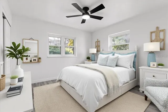 a bed room with a bed and a potted plant