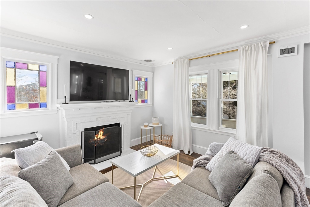 7 Cedar Terrace Milton, MA 02186 - Photo 13 of 34 a living room with furniture a fireplace and a flat screen tv