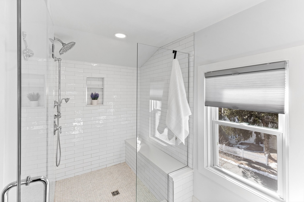 7 Cedar Terrace Milton, MA 02186 - Photo 22 of 34 a bathroom with a glass shower door and a glass door
