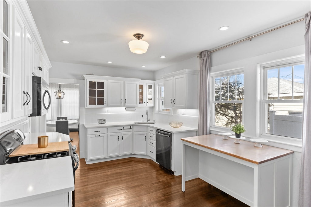 7 Cedar Terrace Milton, MA 02186 - Photo 7 of 34 a large kitchen with kitchen island a sink stainless steel appliances and cabinets