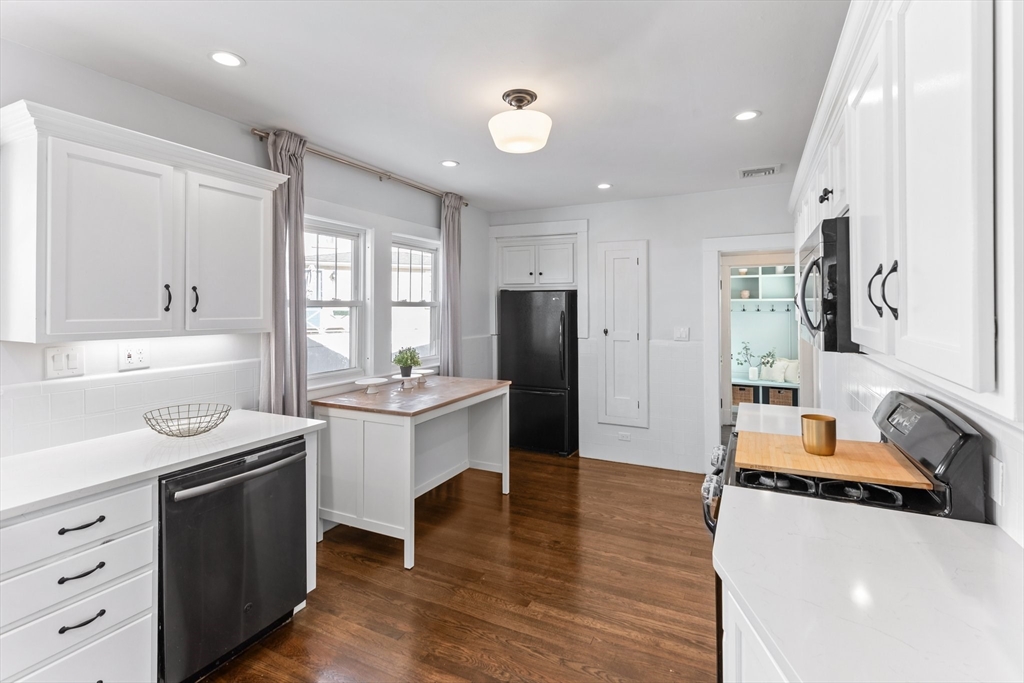 7 Cedar Terrace Milton, MA 02186 - Photo 8 of 34 a kitchen with stainless steel appliances a sink stove and refrigerator