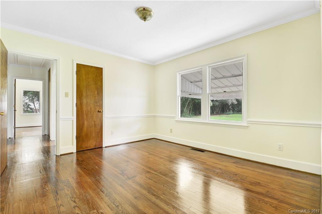 1297 Pinewood Road Rock Hill, SC 29730 - Photo 2 of 15 a view of an empty room with wooden floor and a window