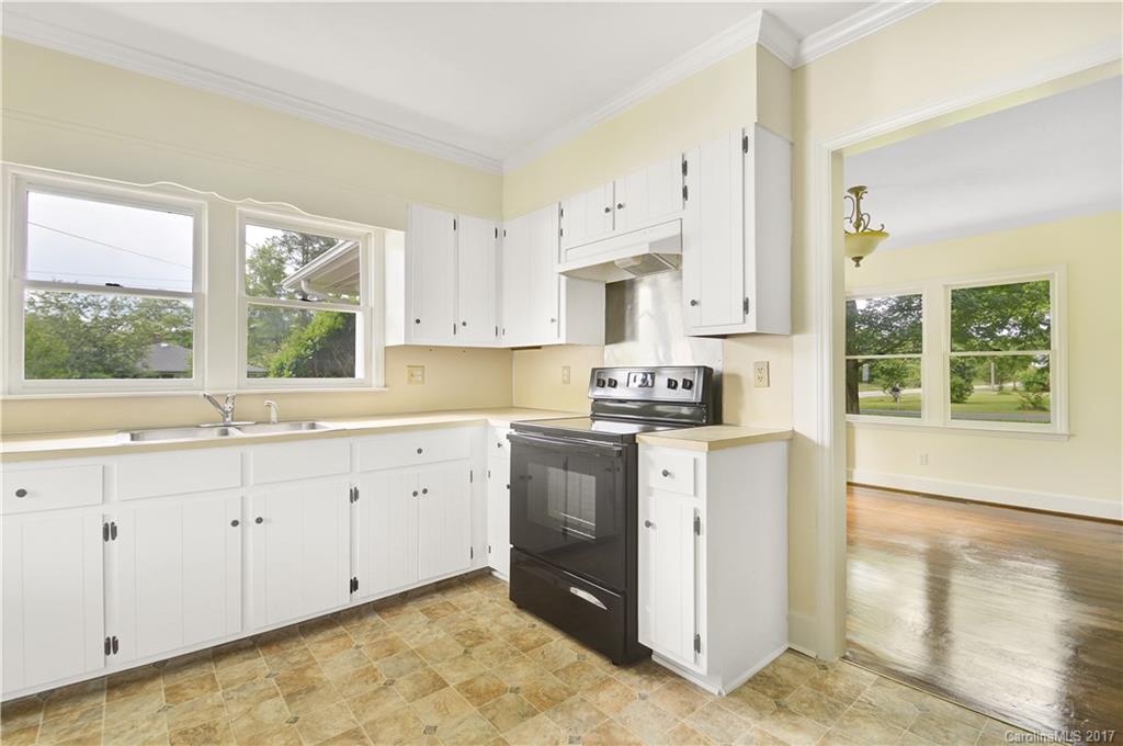 1297 Pinewood Road Rock Hill, SC 29730 - Photo 4 of 15 a kitchen with granite countertop white cabinets white appliances a sink and a large window