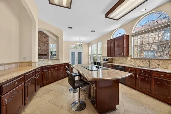 a kitchen with granite countertop a sink cabinets and window