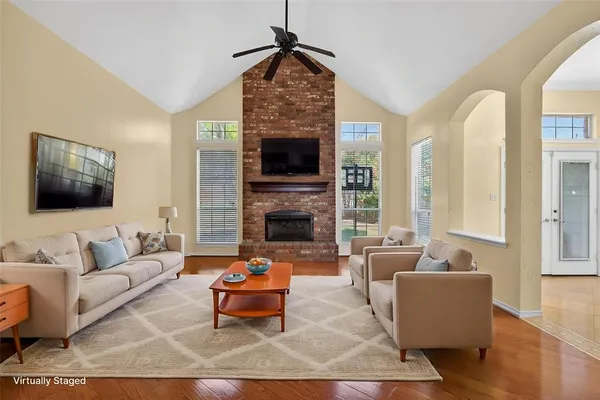 a living room with furniture fireplace and window