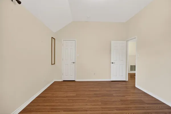 a view of a room with wooden floor