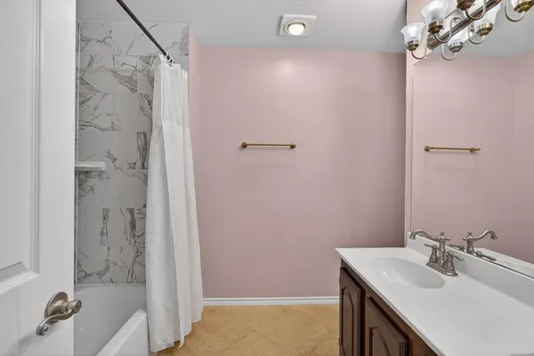 a bathroom with a sink a mirror and a shower