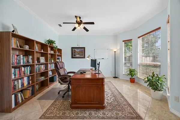 a living room with furniture and a book shelf