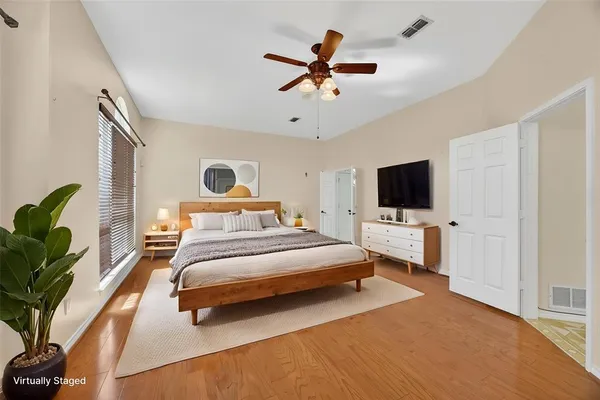 a bedroom with a bed and a flat screen tv