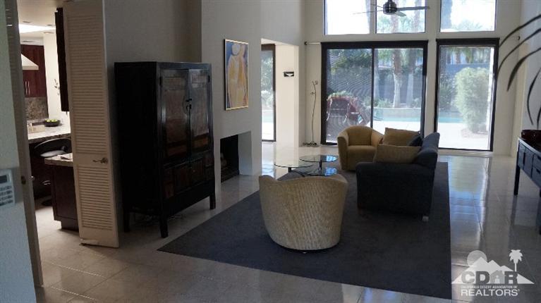 2 Lincoln Place Rancho Mirage, CA 92270 - Photo 14 of 25 a living room with glass door and furniture