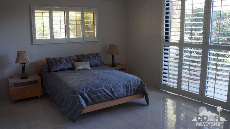 2 Lincoln Place Rancho Mirage, CA 92270 - Photo 16 of 25 a bed sitting in a bedroom next to a window