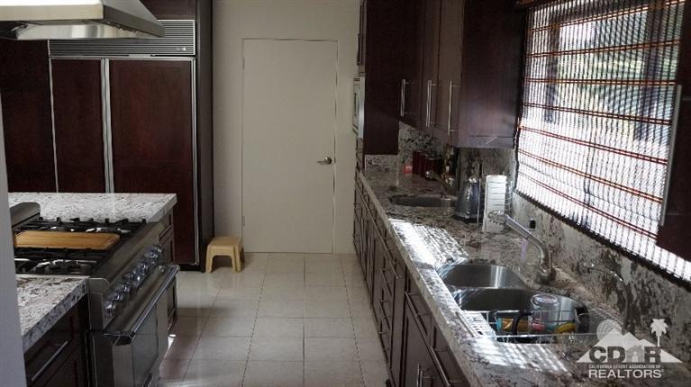 2 Lincoln Place Rancho Mirage, CA 92270 - Photo 5 of 25 a kitchen with granite countertop a stove and a shower