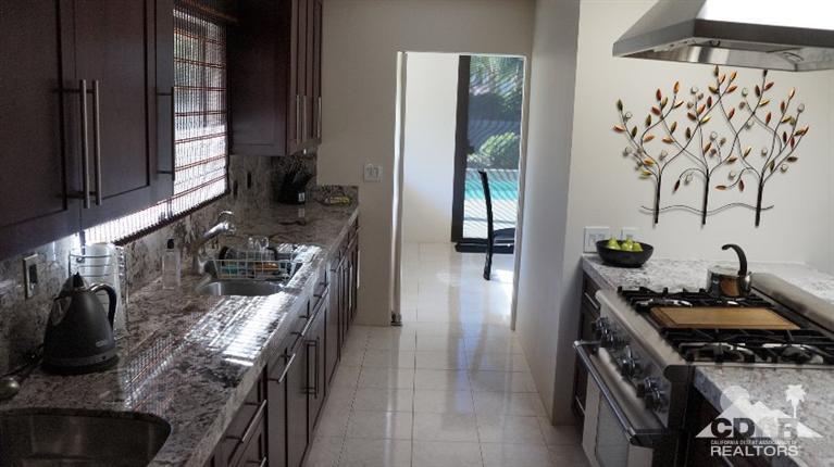 2 Lincoln Place Rancho Mirage, CA 92270 - Photo 7 of 25 a kitchen with stainless steel appliances granite countertop a sink stove and cabinets