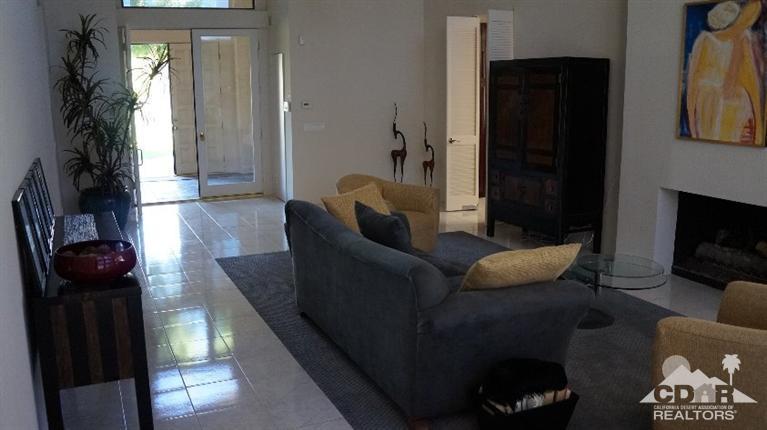 2 Lincoln Place Rancho Mirage, CA 92270 - Photo 10 of 25 a living room with furniture and a fireplace