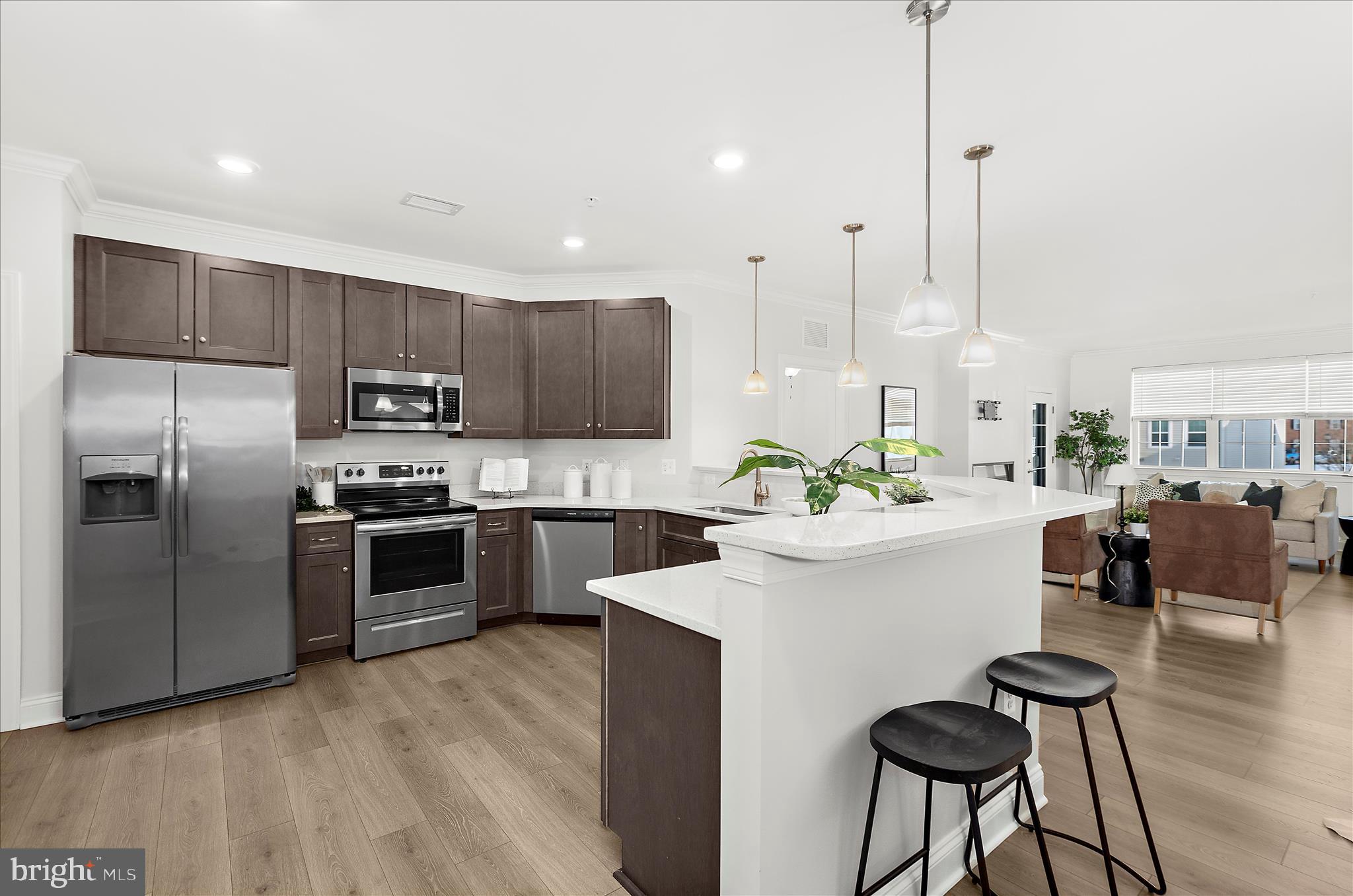 a kitchen with stainless steel appliances kitchen island a refrigerator and a stove top oven
