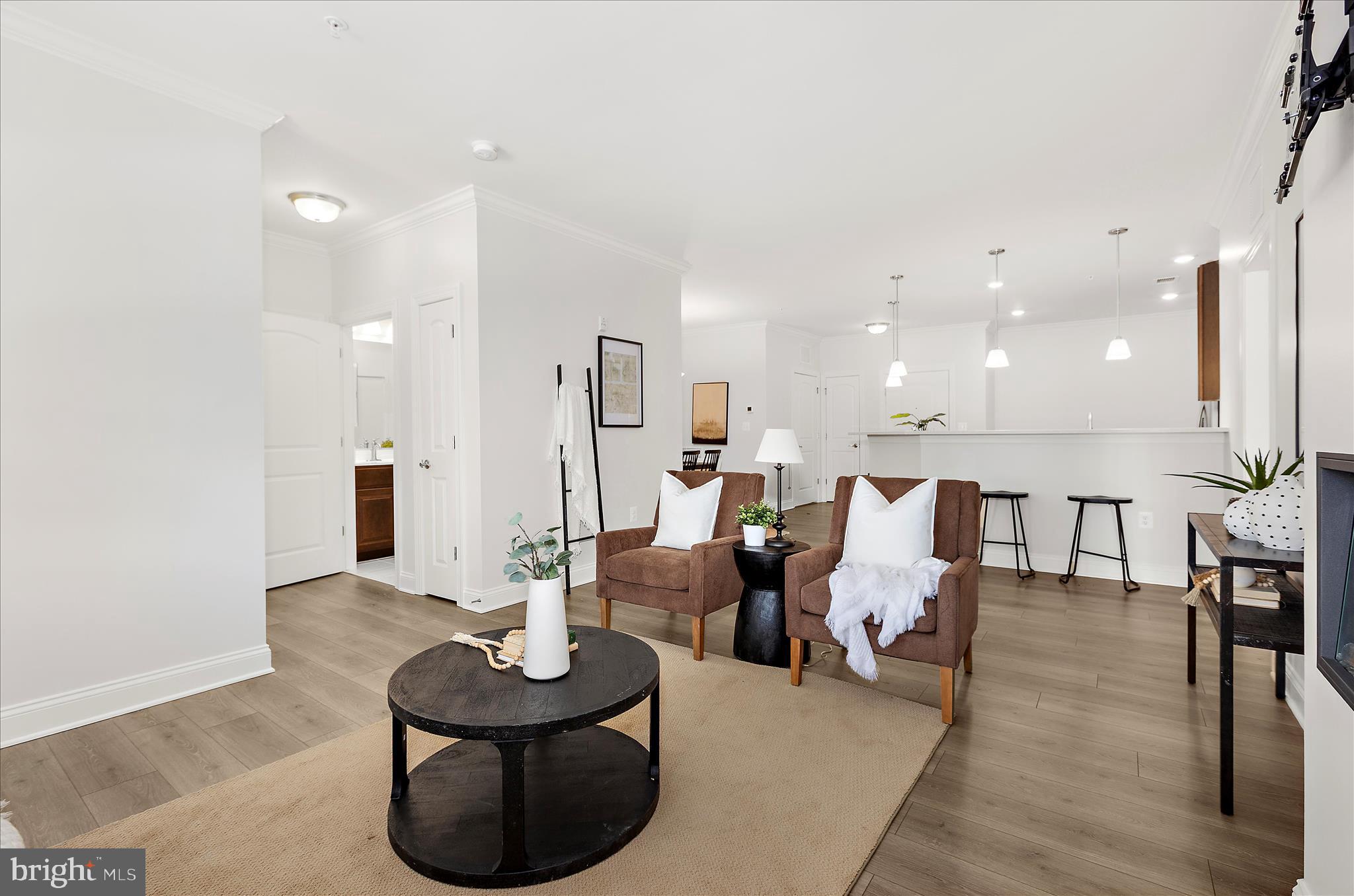 636 Wallingford Road, Unit 3J Bel Air, MD 21014 - Photo 16 of 59 a living room with furniture kitchen view and a chandelier