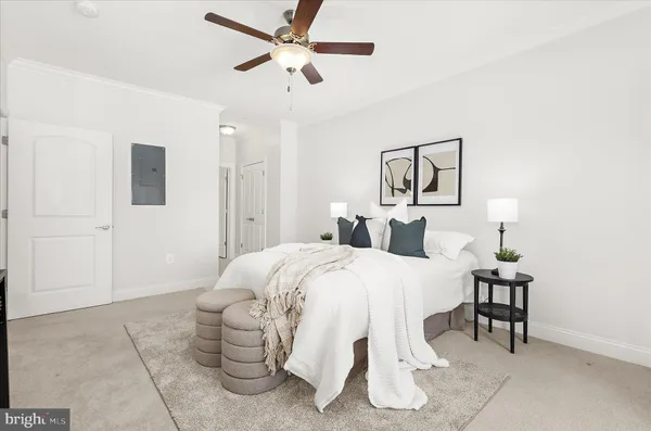 a bedroom with a bed and lamp with the table