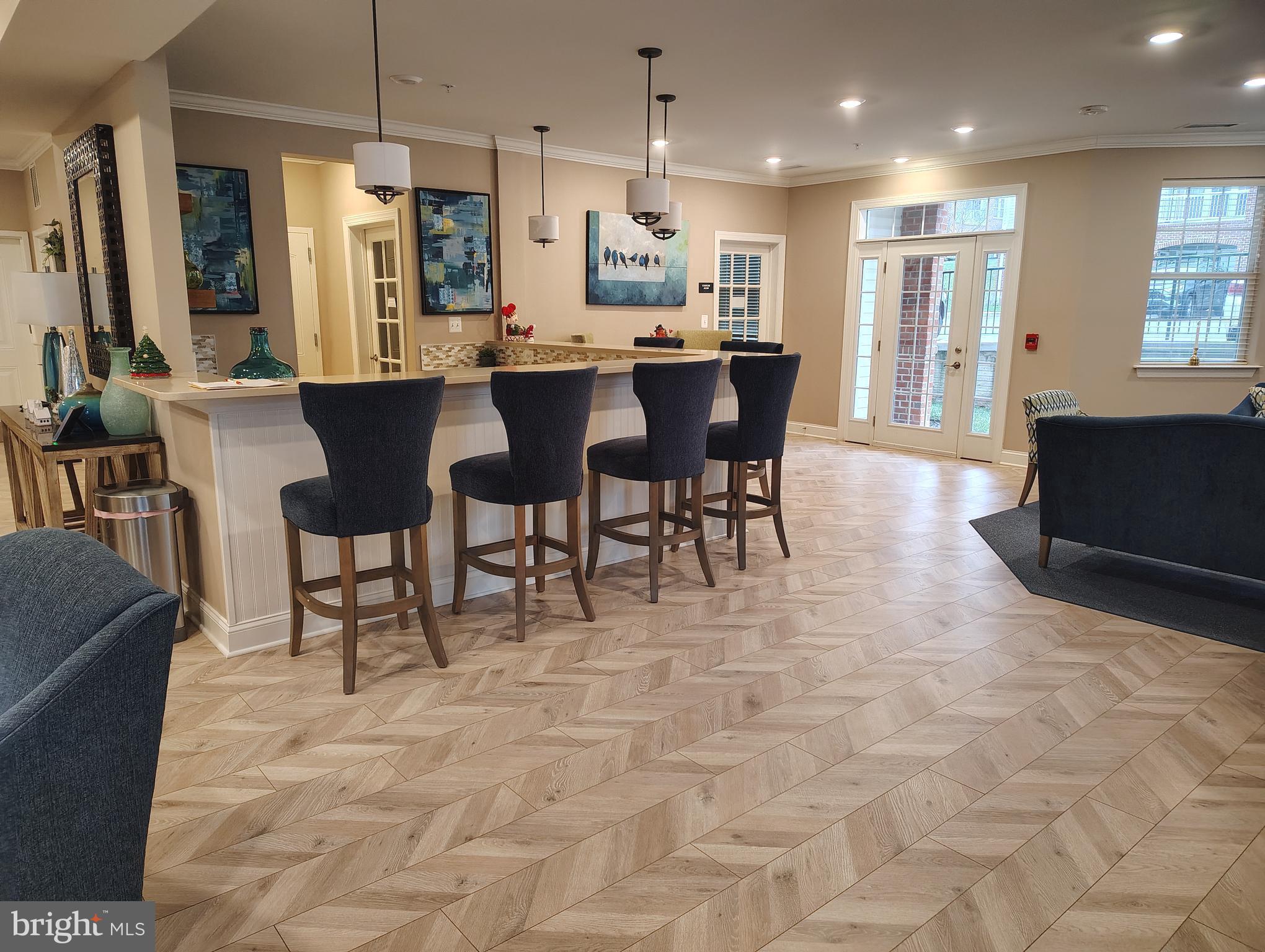 636 Wallingford Road, Unit 3J Bel Air, MD 21014 - Photo 49 of 59 a large dining hall with stainless steel appliances granite countertop a stove a sink a dining table and chairs
