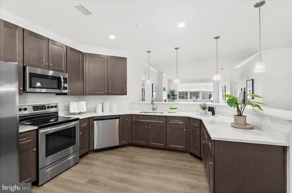 a large kitchen with kitchen island a sink stainless steel appliances and cabinets
