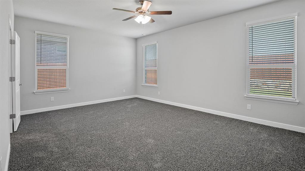 215 Windmill Drive Rhome, TX 76078 - Photo 13 of 37 an empty room with windows and fan