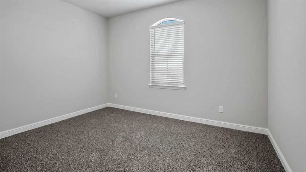 215 Windmill Drive Rhome, TX 76078 - Photo 27 of 37 an empty room with a window