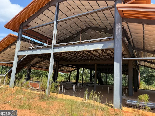 a view of a patio with a table and chairs and potted plants